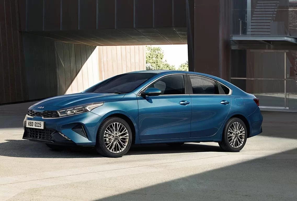 Kia K3 màu xanh đỗ trong không gian kiến trúc hiện đại